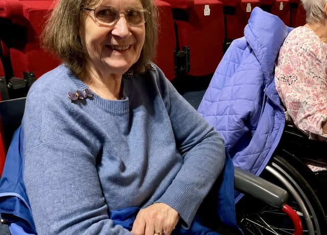 Resident smiling during a trip to the theatre